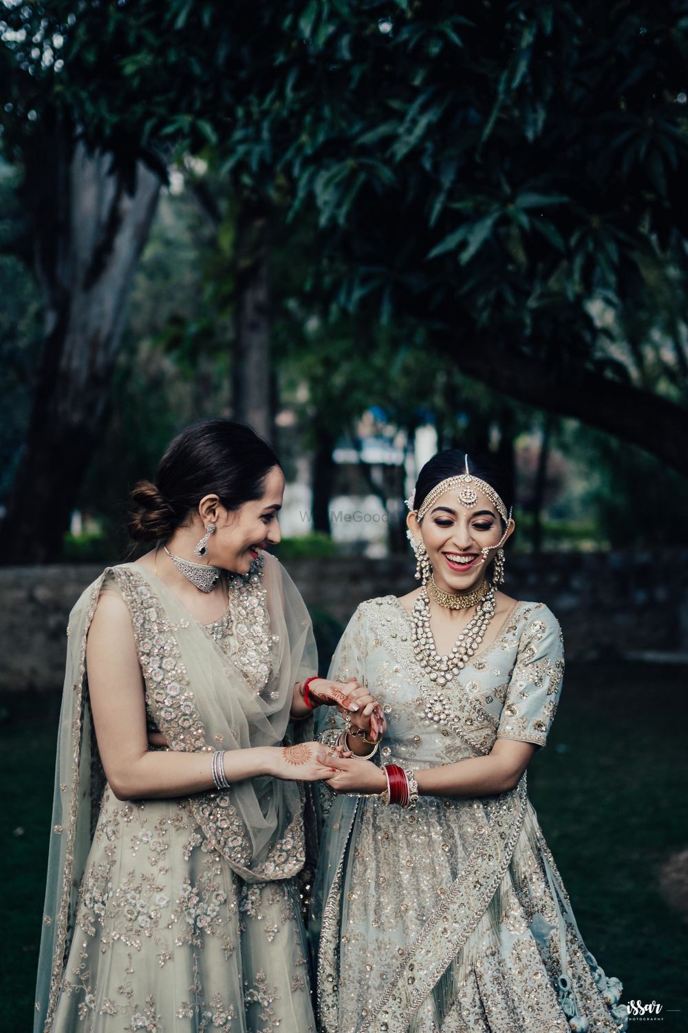 Photo of happy bride and bridesmaid shot in offbeat colours