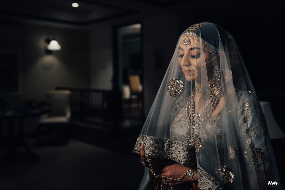 Photo of bride in offbeat lehenga and dupatta as veil