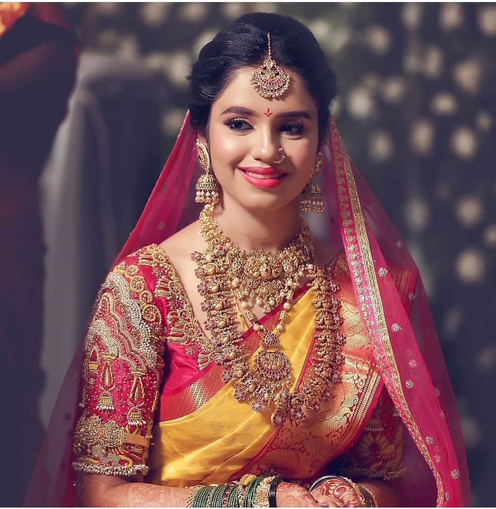 Photo of A south Indian bride in a yellow and red kanjeevaram and gold temple jewellery