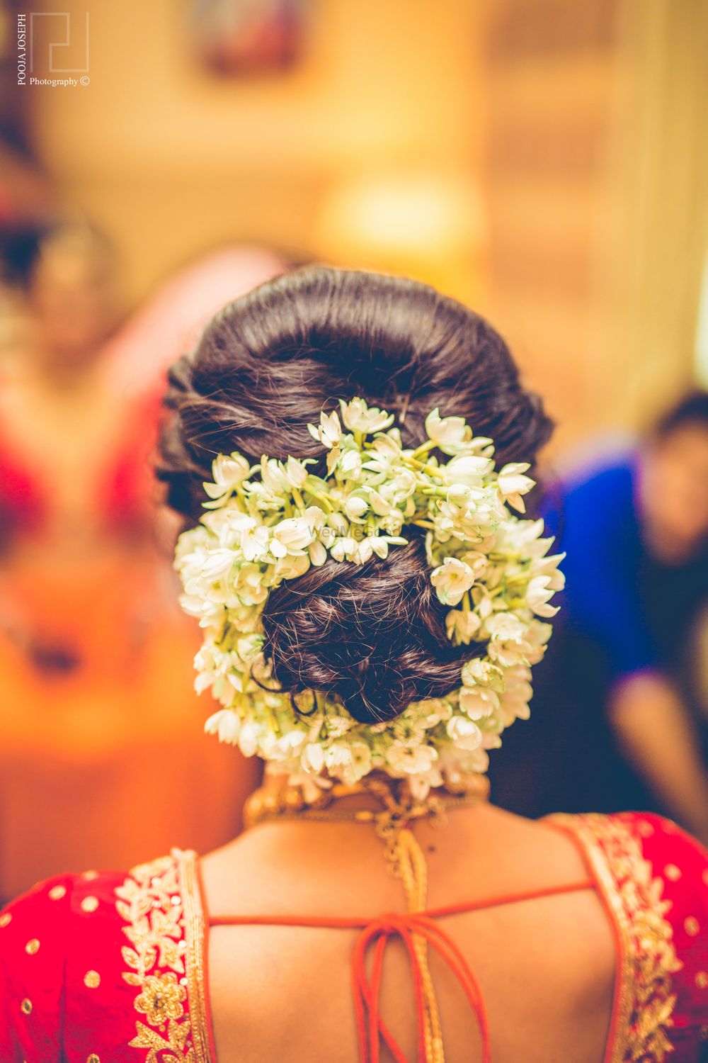 Photo of Braided bun hairstyle with gajra flowers