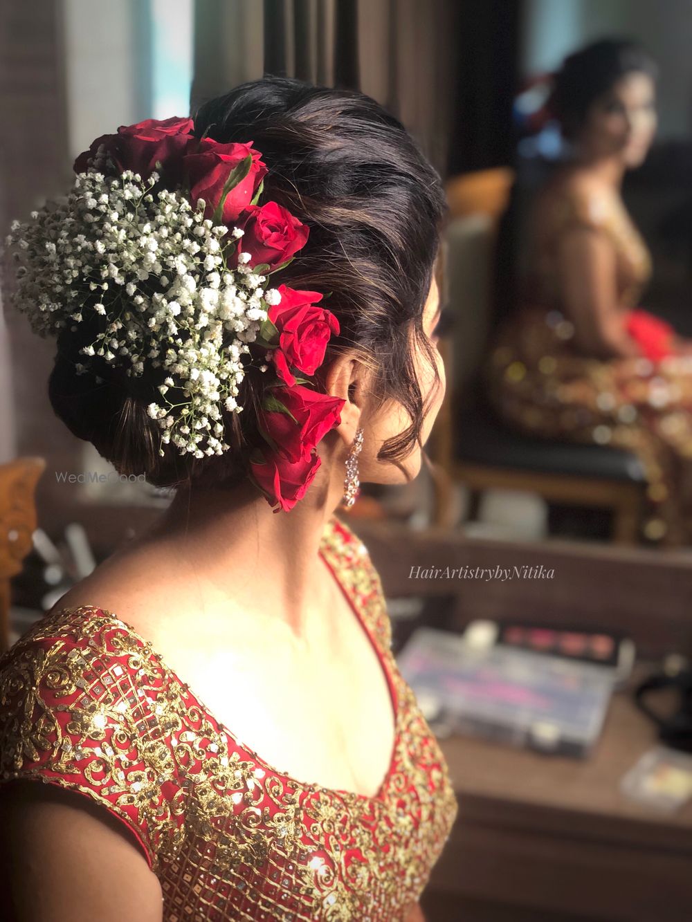 Photo of bridal bun with roses and babys breath