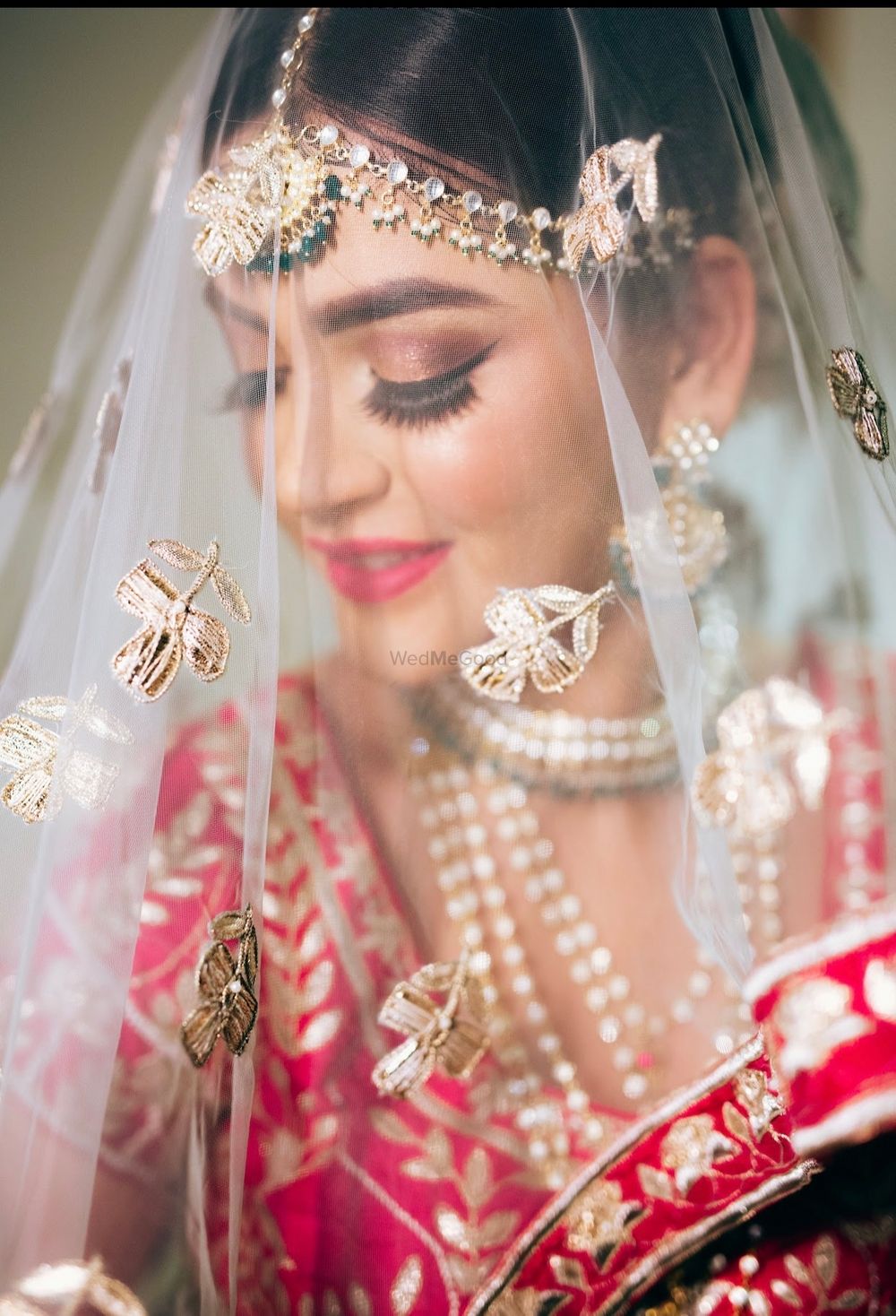 Photo of bride under veil shot