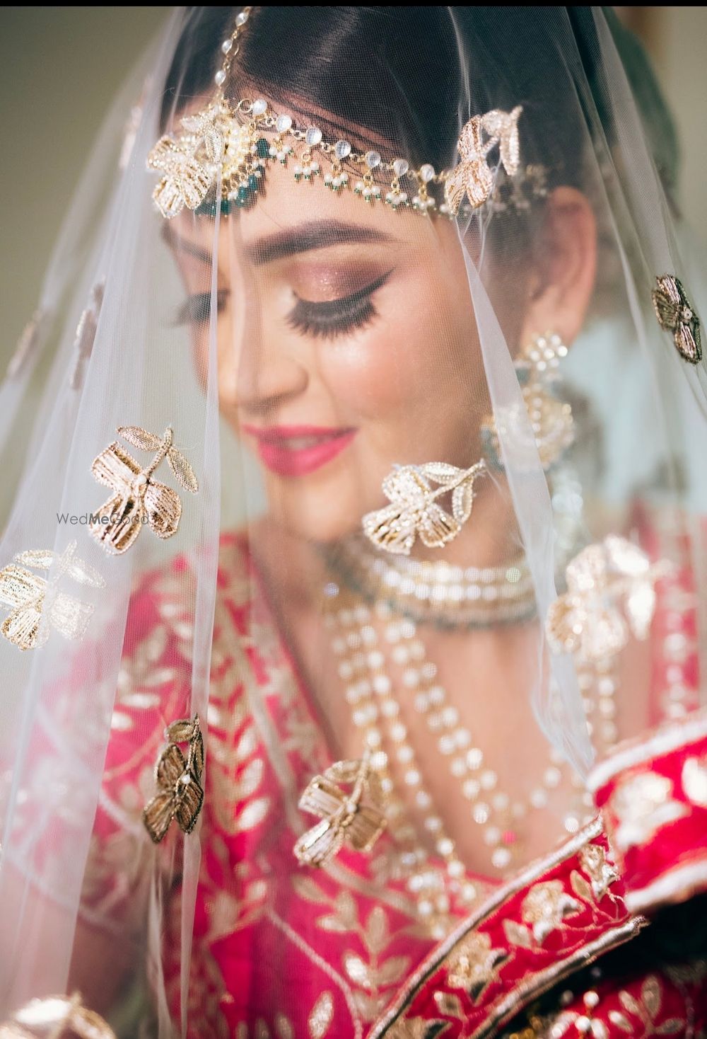 Photo of bride under veil shot