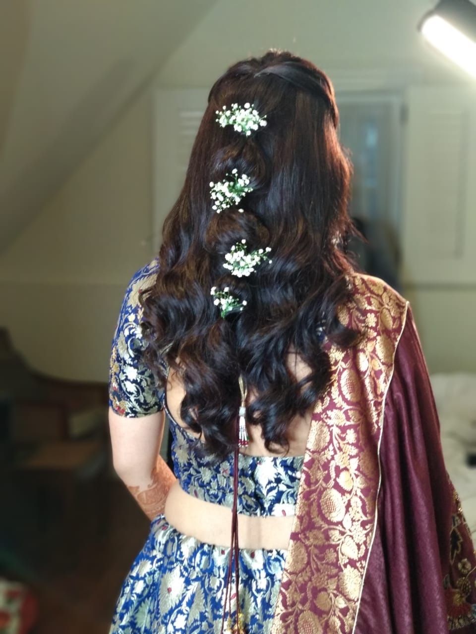 Photo of A bride flaunting her soft curls with hair