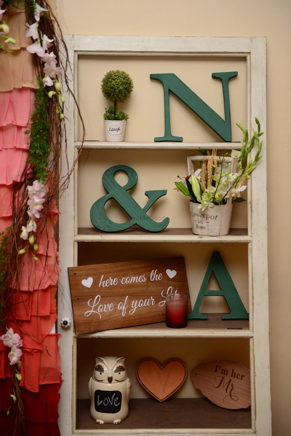 Photo of White Shelf board with Couple Initials and Floral Decor