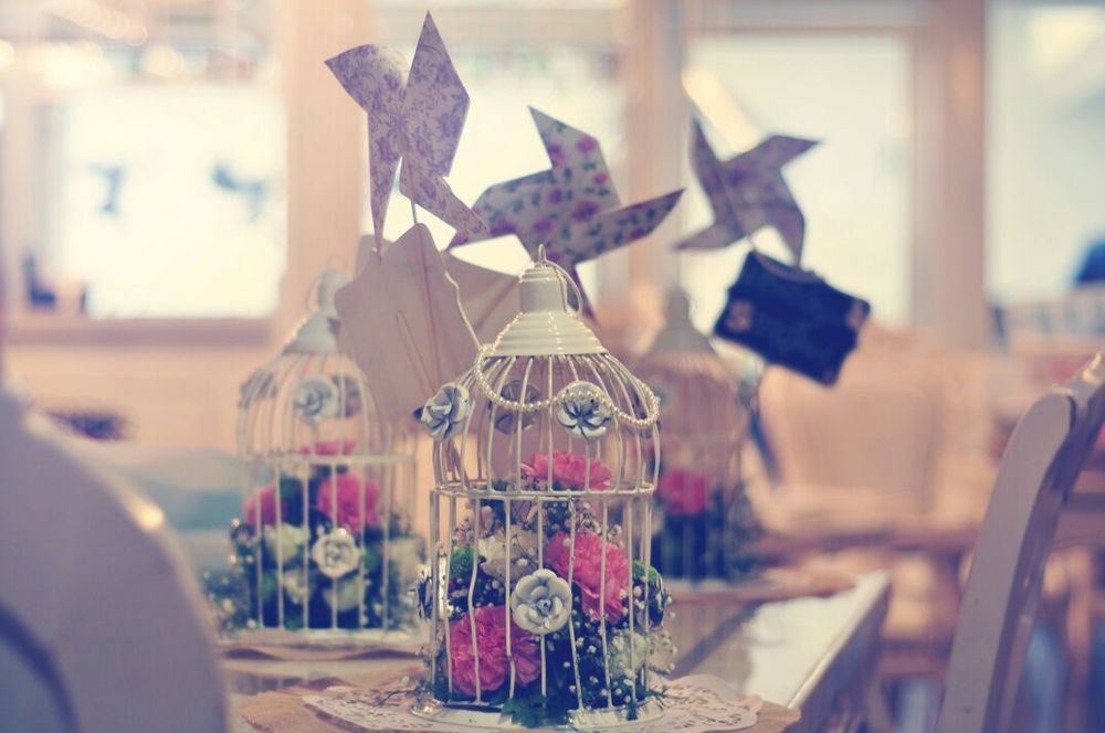 Photo of Bird Cage Decor with Flowers and WIndmills