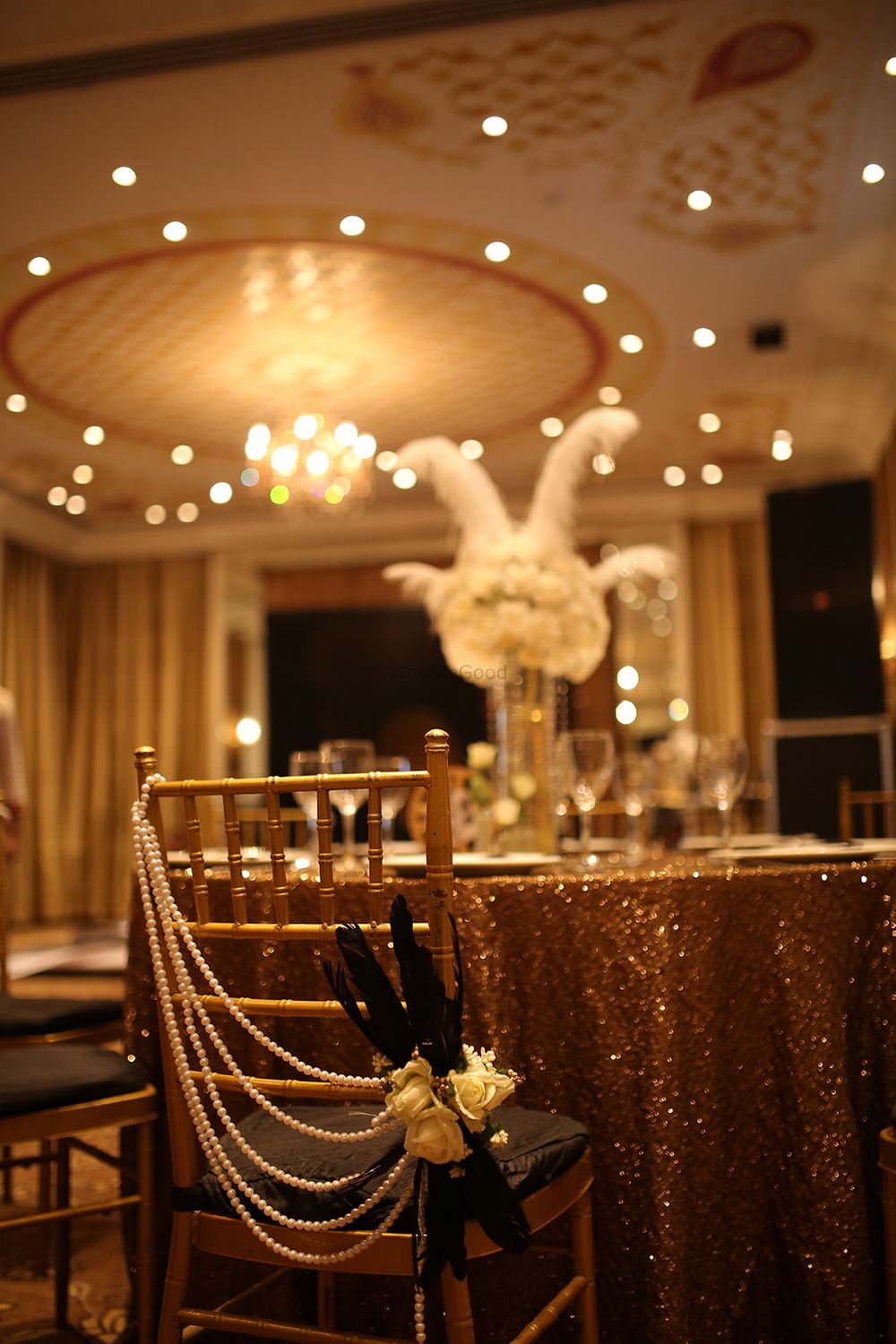 Photo of Gold Table and Seating Decor with Pearl Strings