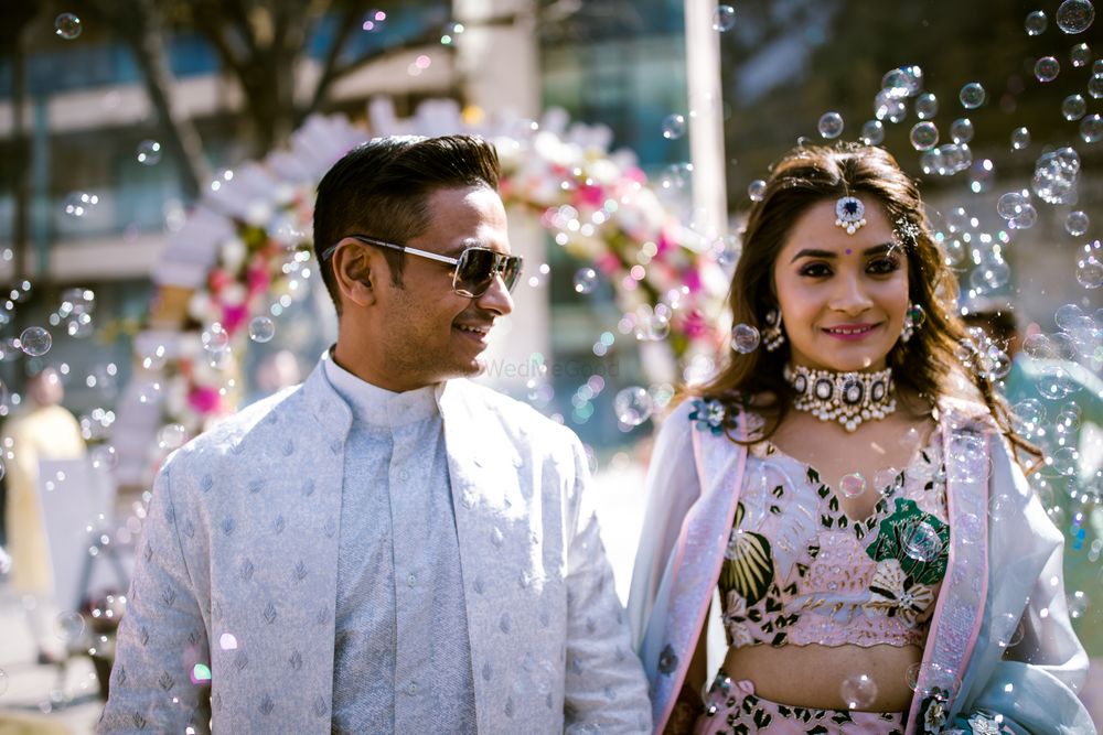 Photo of A bride and groom in coordinated outfits on their engagement