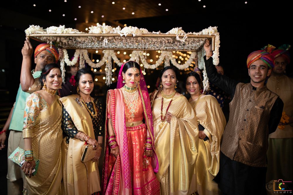 Photo of bridal entry under phoolon ki chadar with bridesmaids