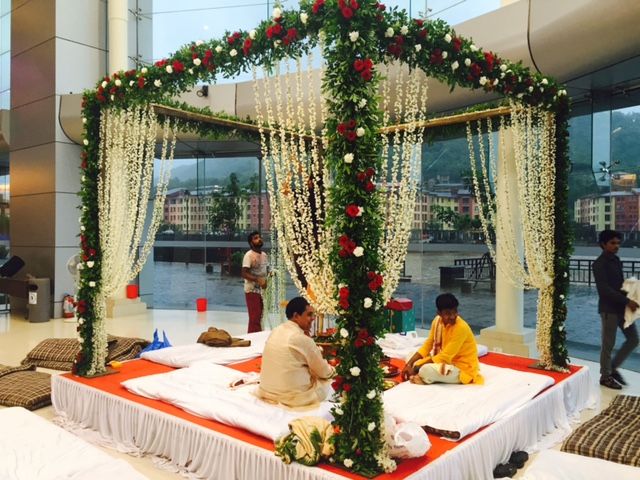 Photo of Green Floral Mandap with White and Red Roses