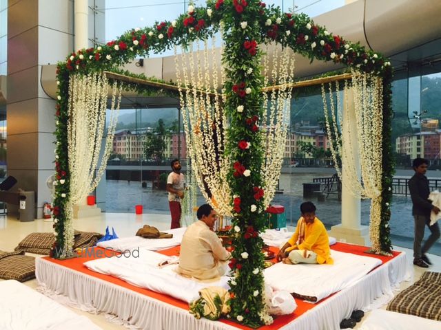 Photo of Green Floral Mandap with White and Red Roses