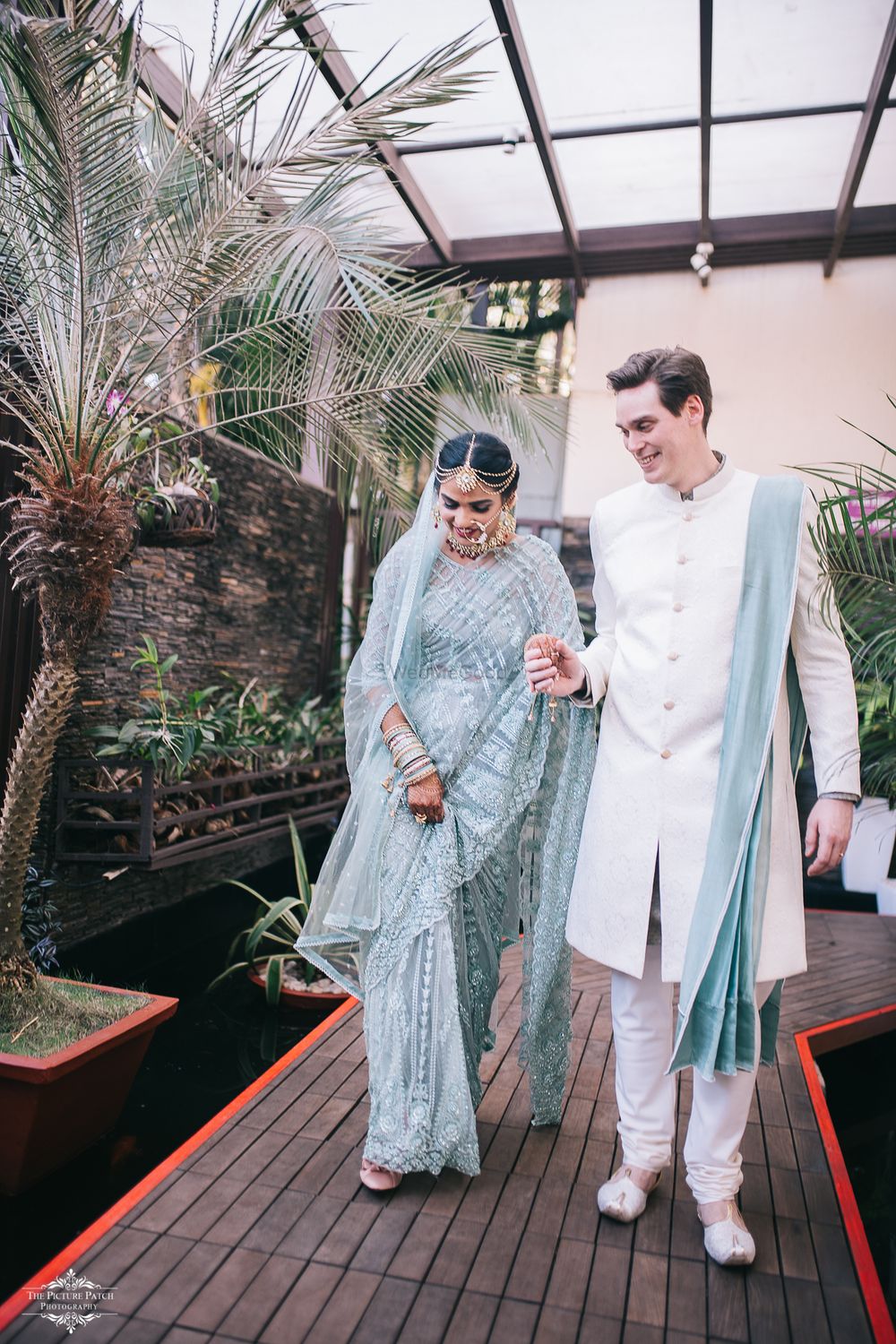 Photo of A couple in color coordinated outfits on their wedding day