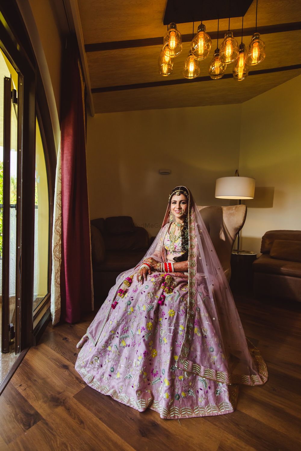 Photo of bride in a simple lavender lehenga with floral work