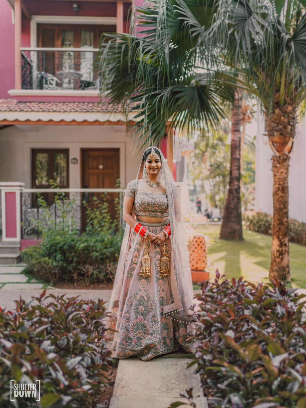 Photo of bride posing in a simple blush pink lehenga