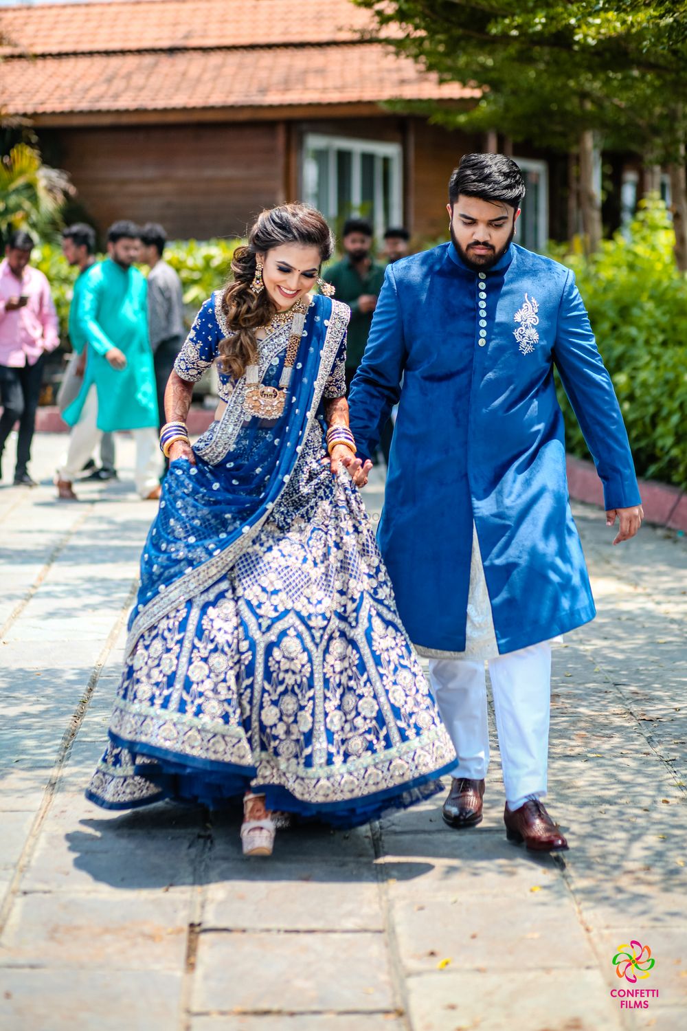 Photo of matching bride and groom on mehendi in blue