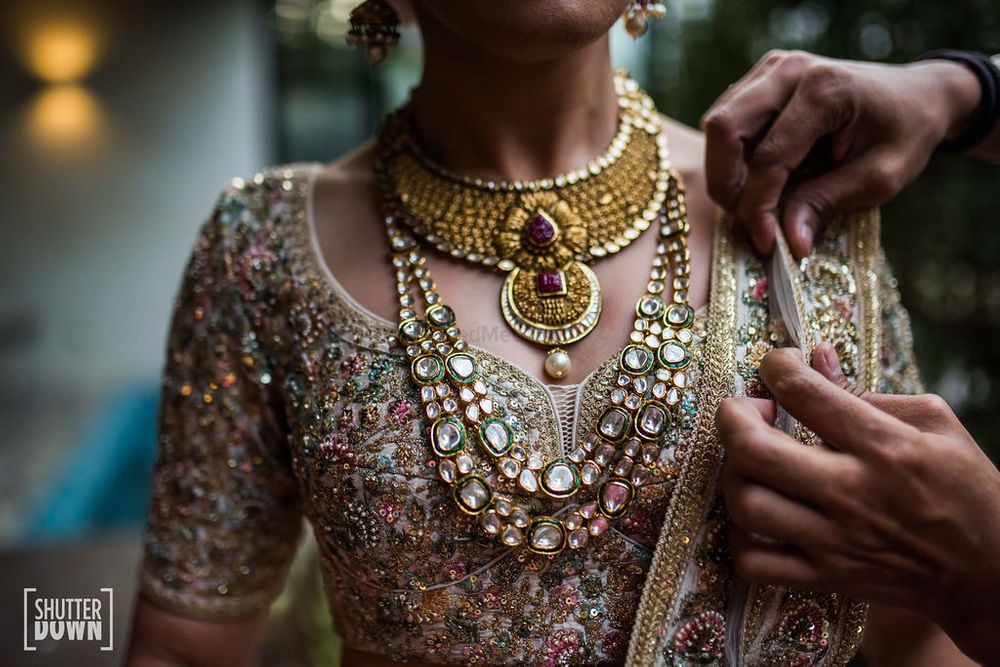 Photo of layered bridal necklace with sabyasachi lehenga
