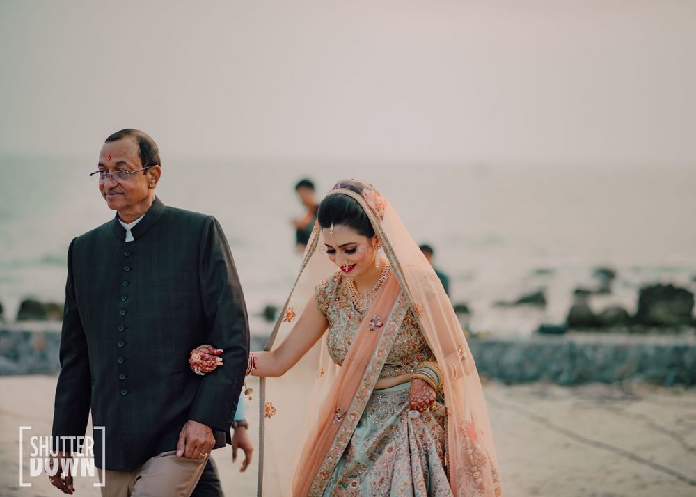 Photo of bride entering her wedding with her father