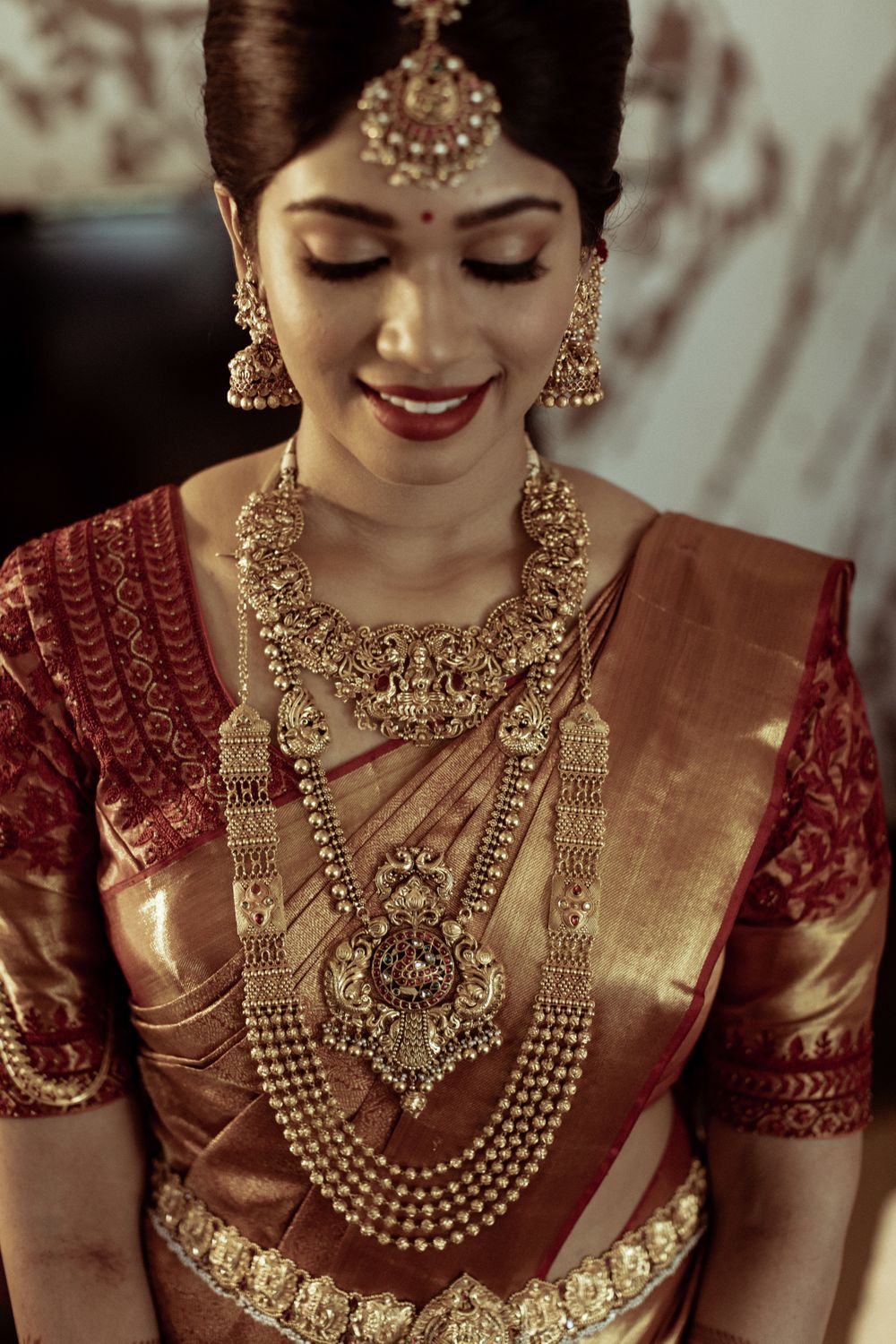 Photo of gold bridal look with layered temple necklaces