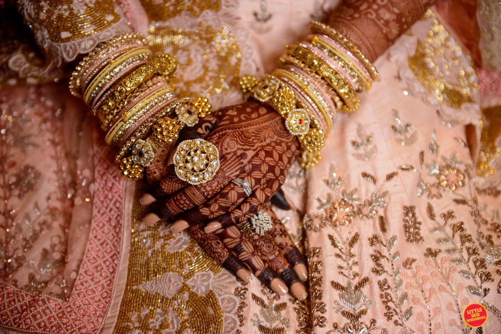 Photo of bridal hands with cocktail rings and kadas