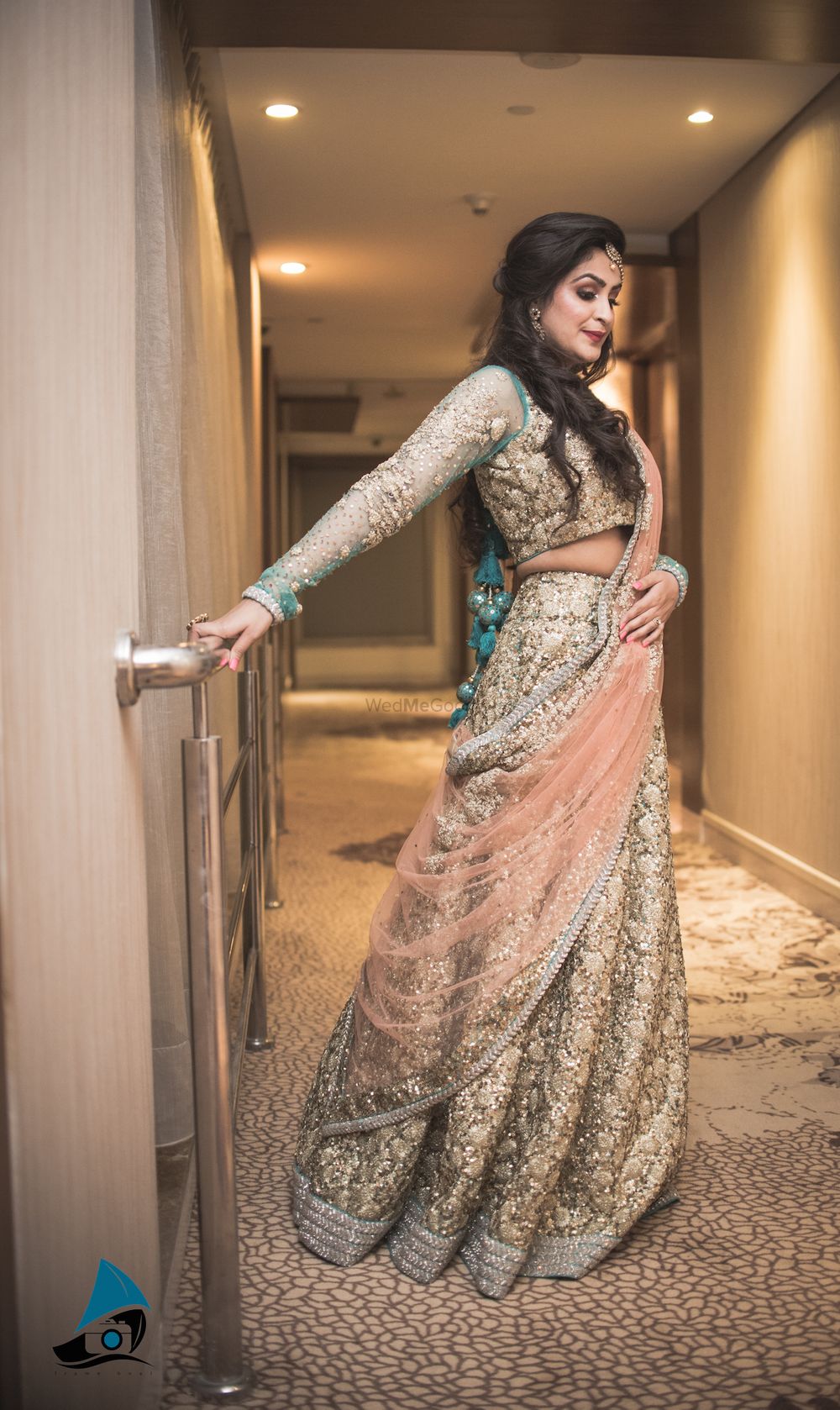 Photo of Shimmer Gold Lehenga with Teal Border