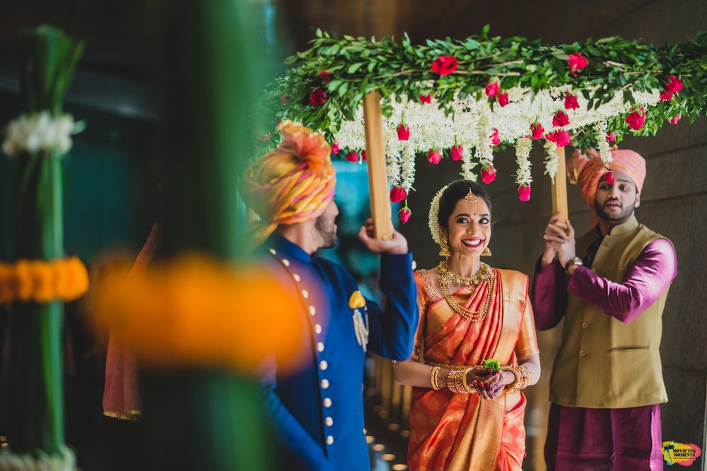Photo of A south Indian bride entering under a phoolon ki chaadar