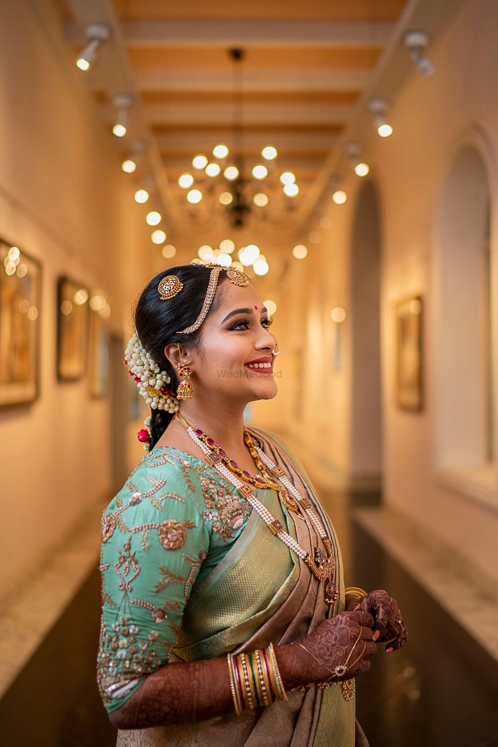 Photo of A south Indian bride with a unique, embroidered blouse on her wedding day