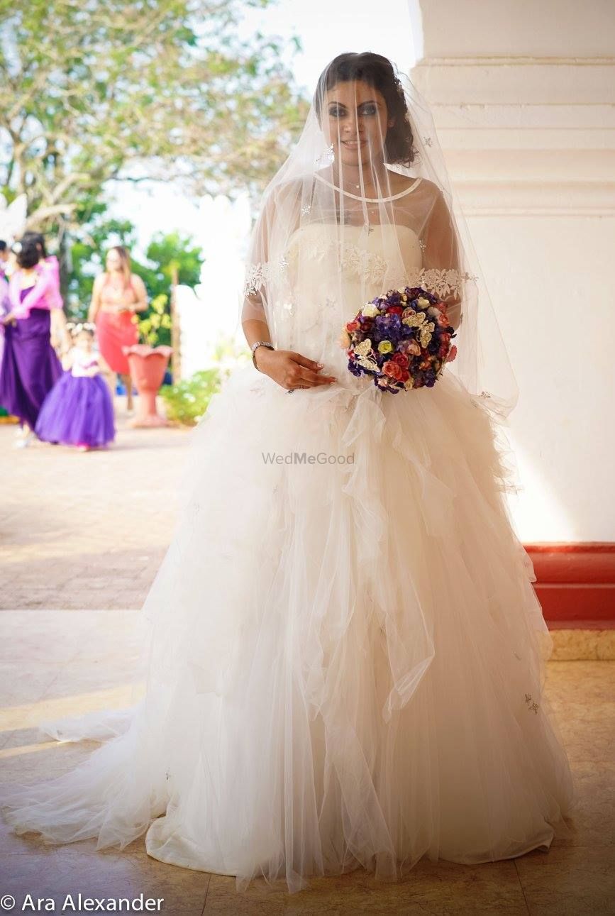 Photo of White Frill Christian Wedding Gown with Floral Bouquet