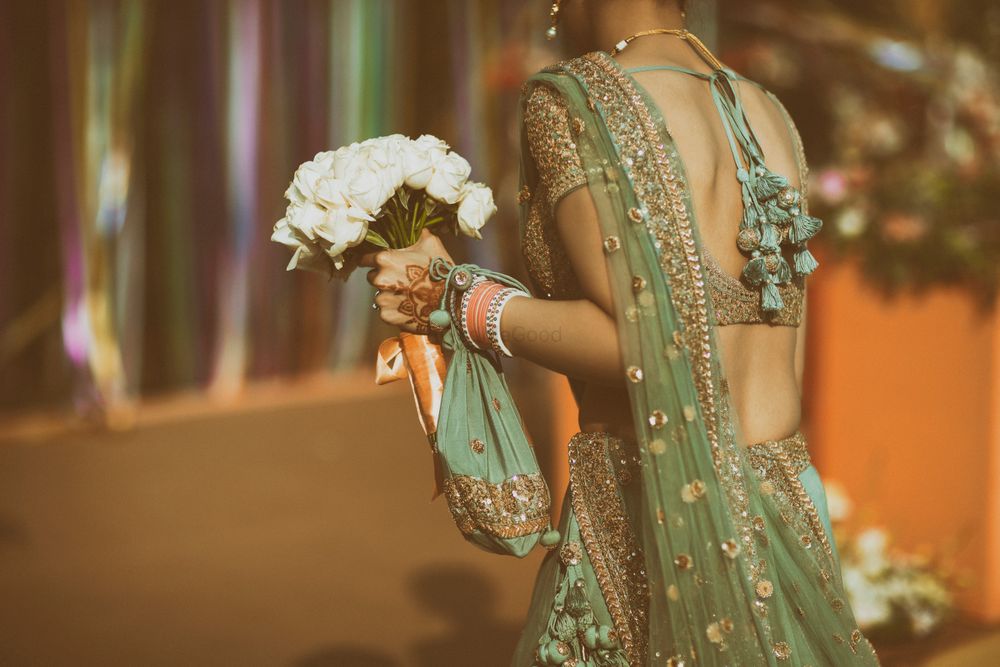 Photo of matching bridal lehenga and bridal potli