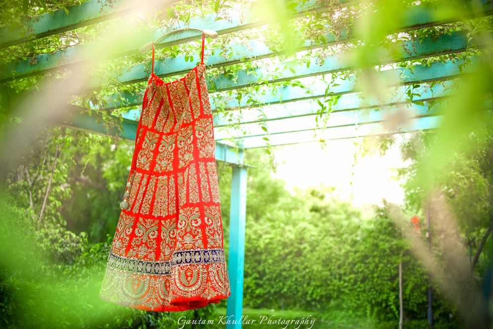 Photo of Red and Gold Lehenga on a Hanger