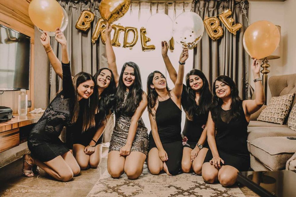 Photo of bachelorette party decor in black and gold