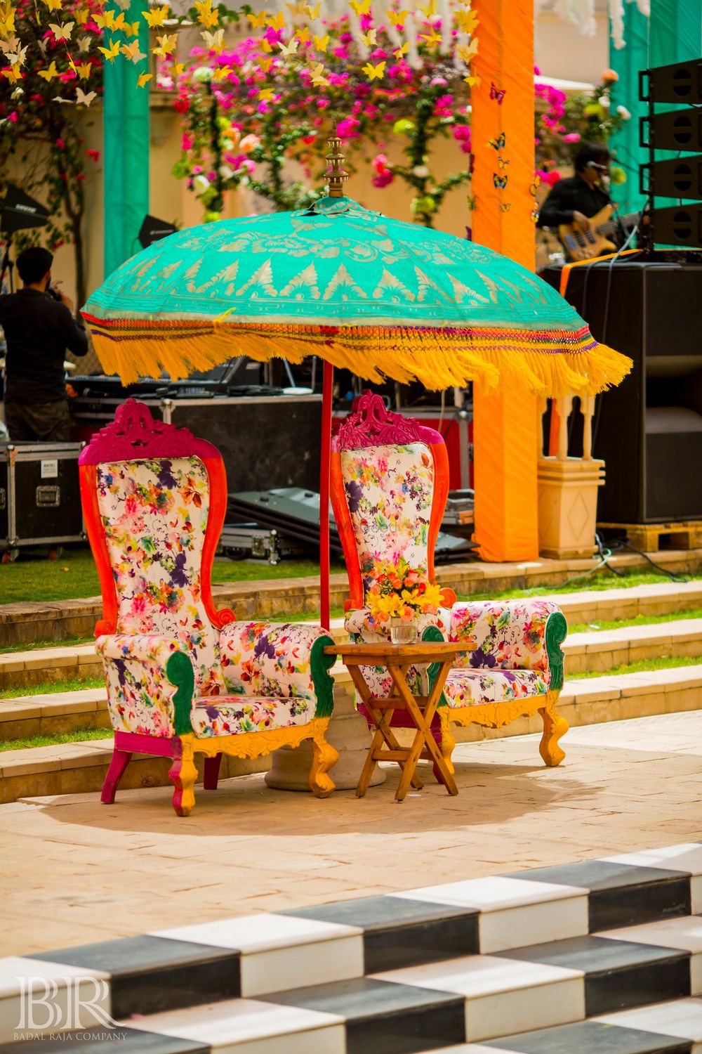 Photo of Printed wooden chairs with a standing umbrella for mehndi decor