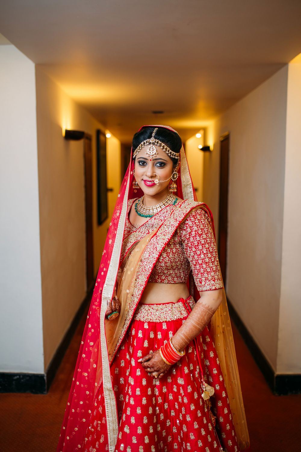 Photo of Red and Gold Lehenga with Gold Jewelry