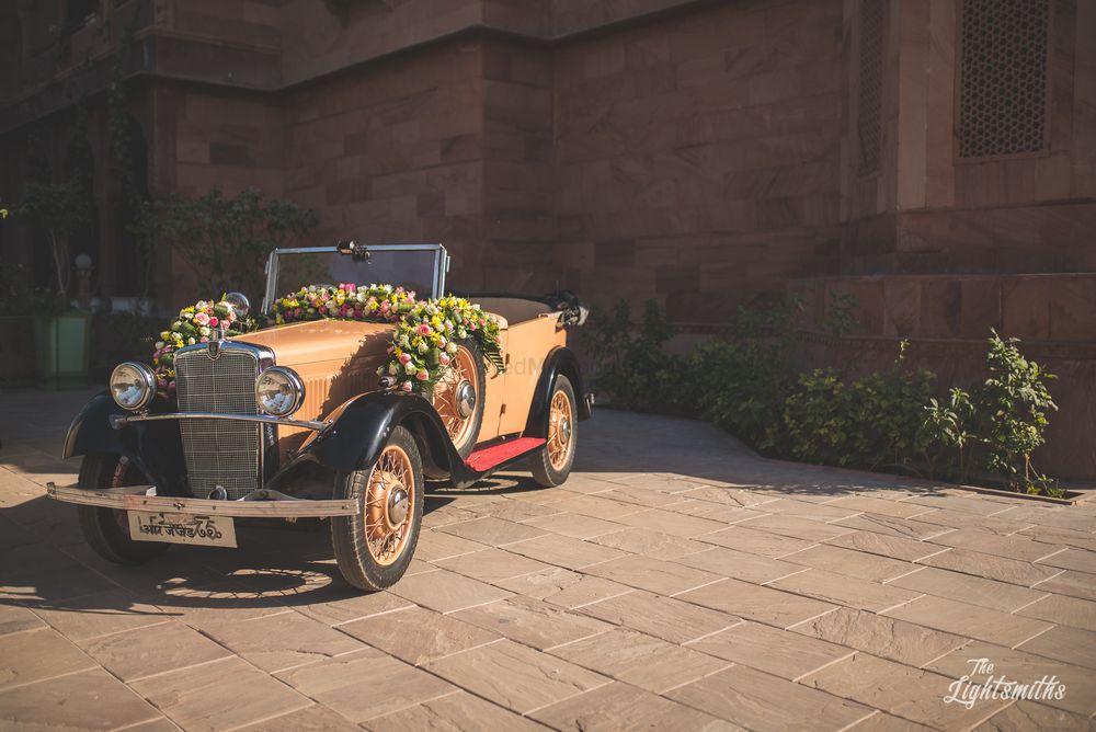 Photo of A vintage car decorated with flowers.