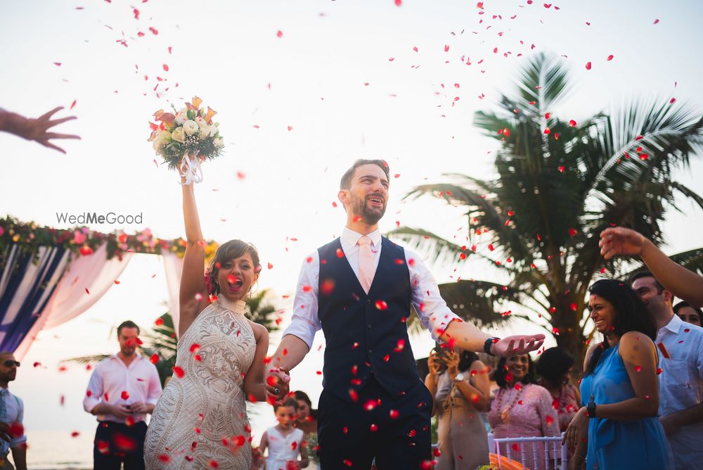 Photo of A bright and happy couple entering together.