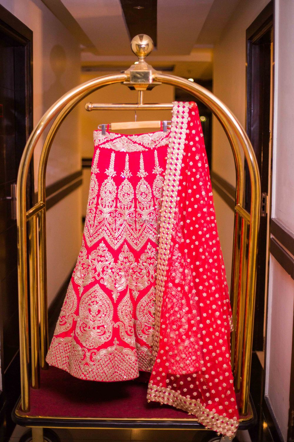 Photo of Red Bridal Lehenga with Dupatta on a Hanger