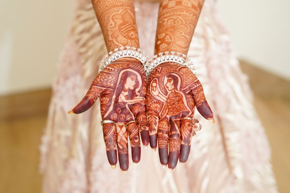 Photo of Mehndi design with a guy proposing to a girl.