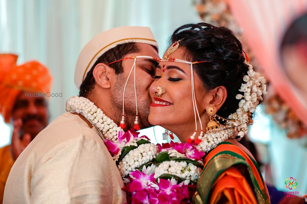 Photo of Groom kissing his bride after the wedding ceremony.