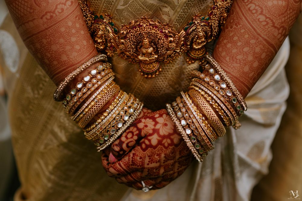 Photo of A shot of beautiful gold waistbelt and bridal bangles.