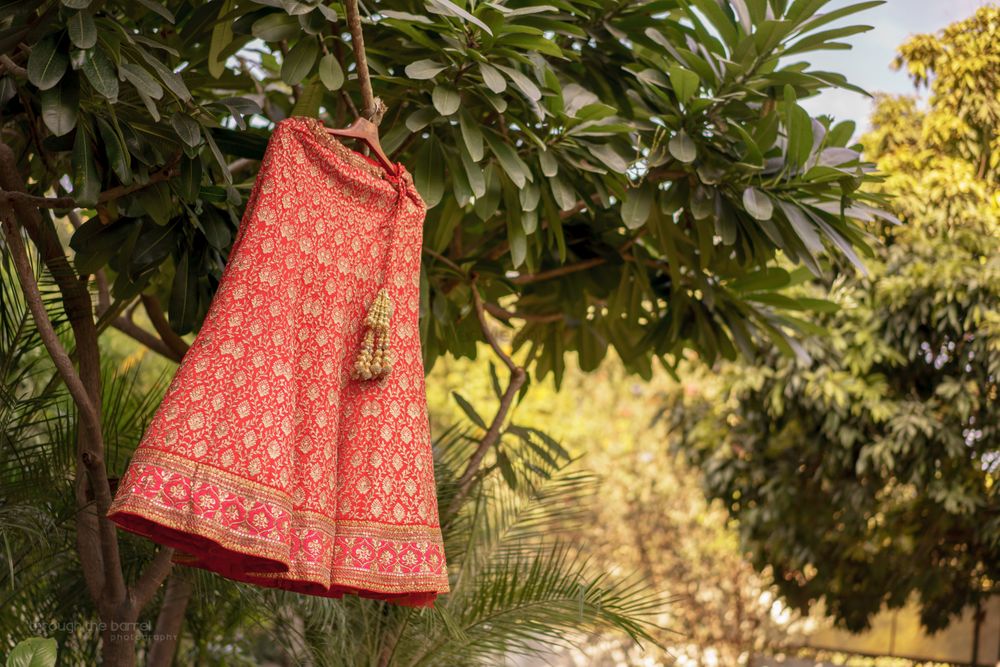 Photo of Red and Gold Motifs Lehenga on a Hanger