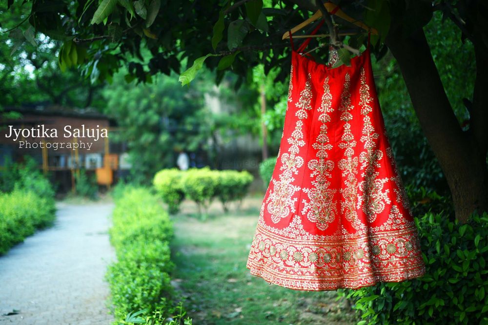 Photo of Red Bridal Lehenga with Gotra Patti Work on a Hanger