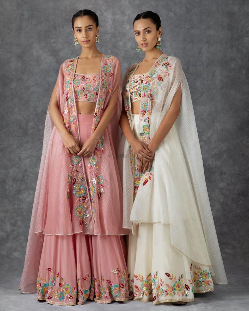 Photo of Whit and Pink lehengas with cape style dupatta. Suits well for gromm's or bride's sister.