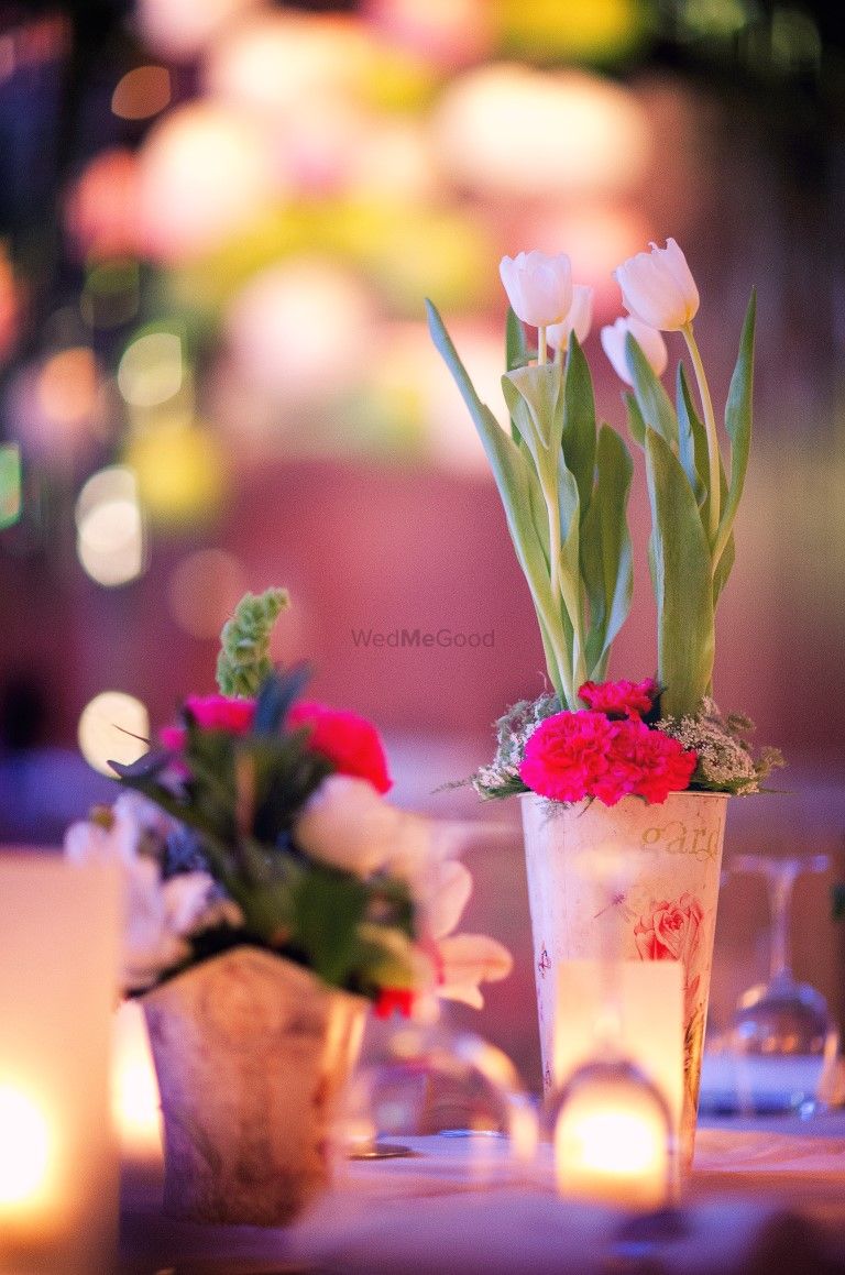 Photo of Vintage glass with tulips as centerpiece