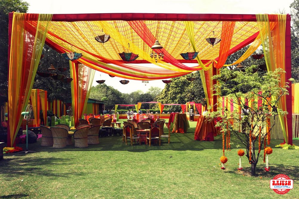 Photo of Yellow and Orange Tents with hanging Floral Decor