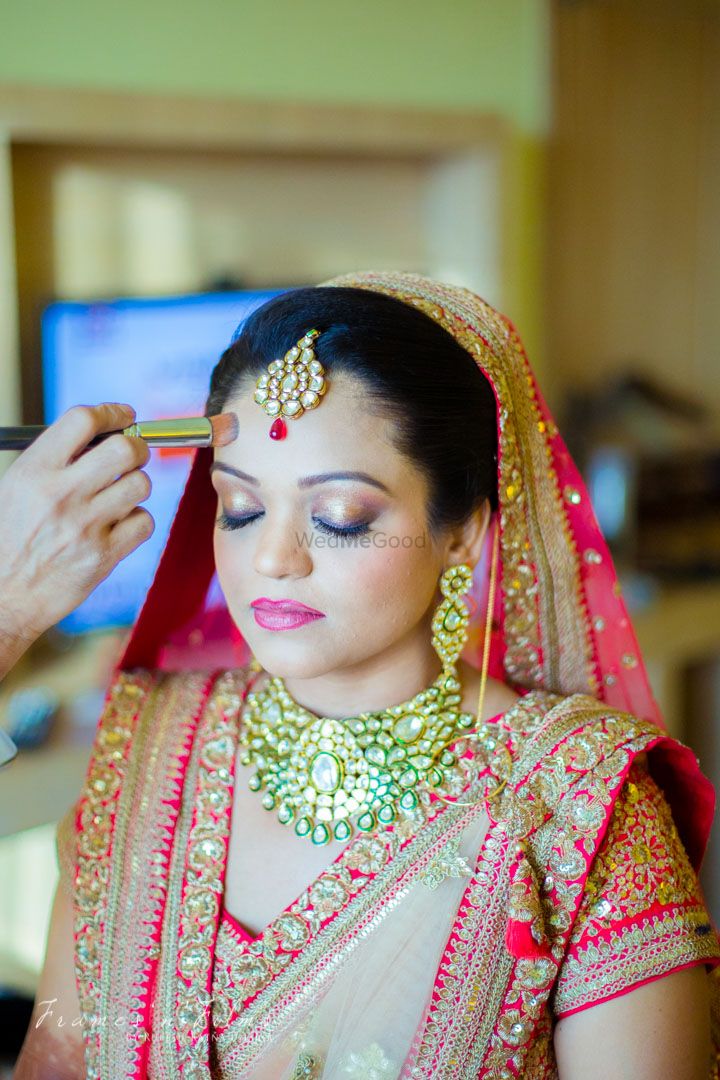 Photo of Bride getting ready with choker in emerald
