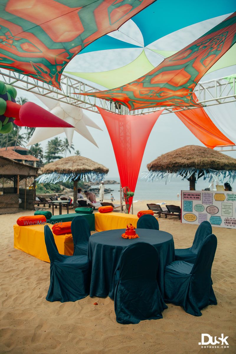 Photo of Beach wedding decor with orange and blue theme