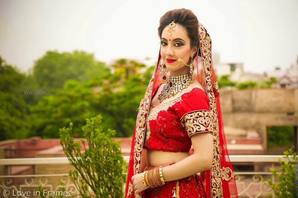 Photo of Bride in Red Lehenga and Gold Nath