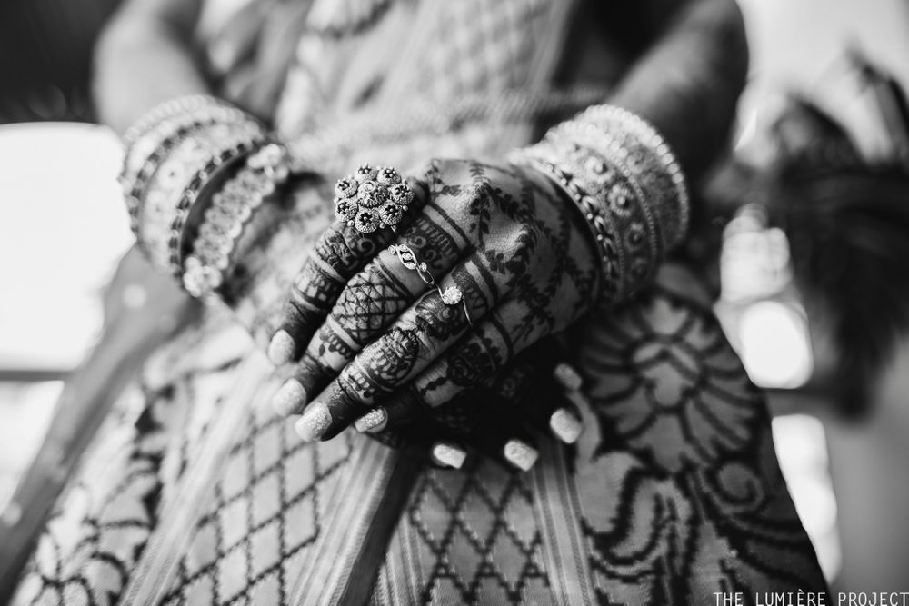 Photo of black and white bridal hands shot