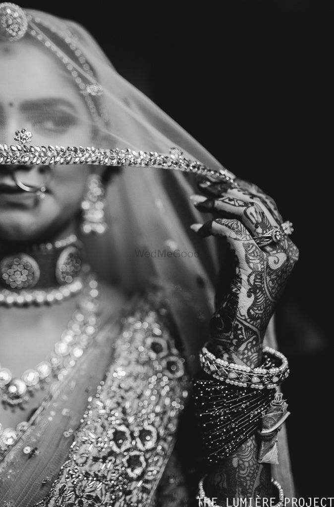 Photo of black and white bridal close up portrait with dupatta as veil