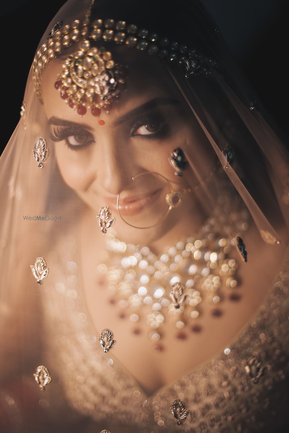 Photo of bride under veil shot