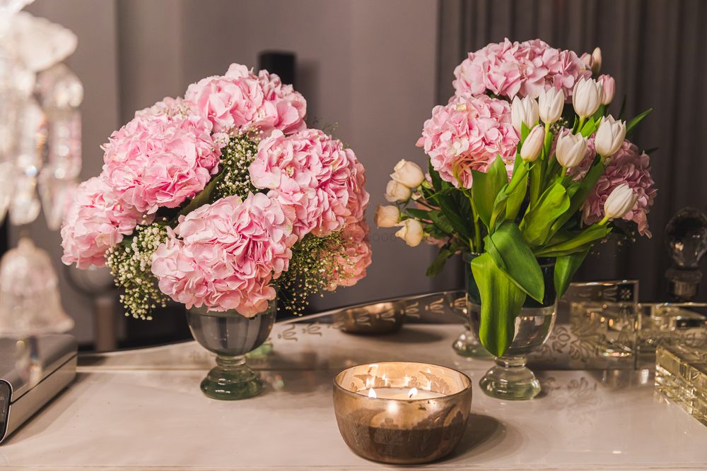 Photo of Small flower vases used as table centerpieces